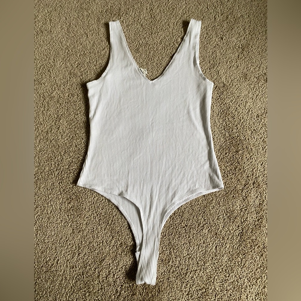 Garage. Size small, white ribbed bodysuit. Gently used and excellent condition